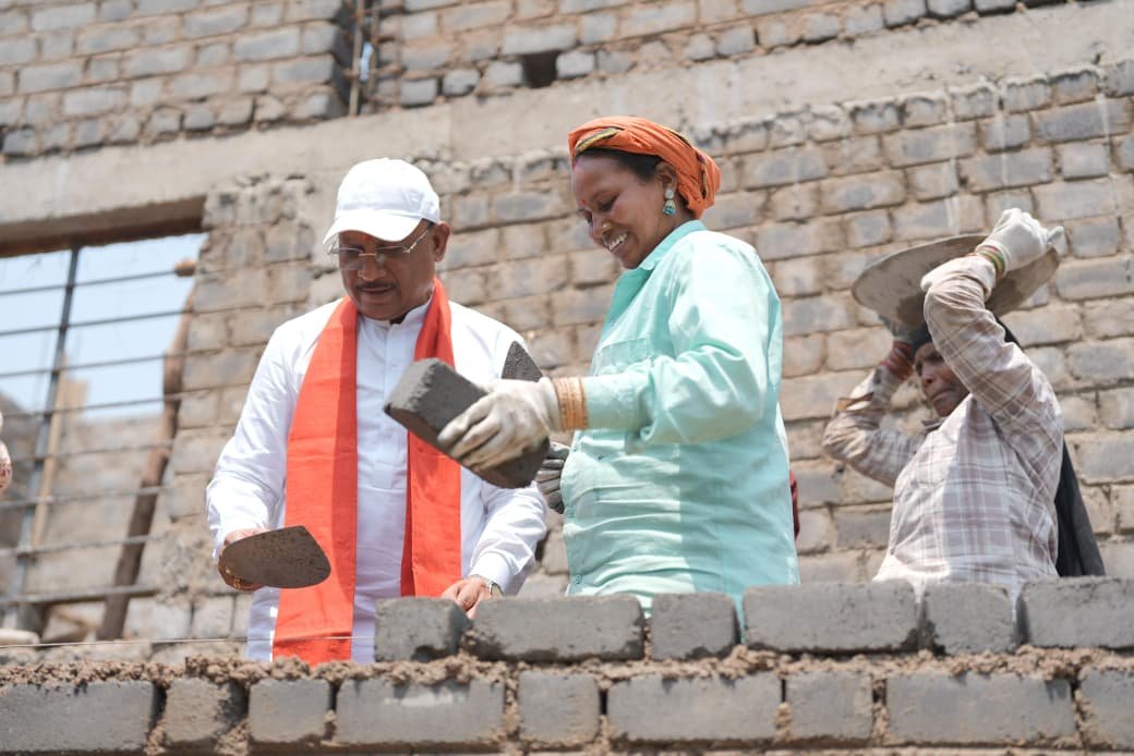 Good governance in brick and mortar: Ground leadership demonstrated by joining with workers in the construction of Panchayat buildings