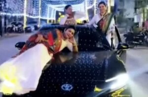 Dangerous stunt by 3 young women on a moving car! One lay on the bonnet, while others danced while hanging onto the doors.